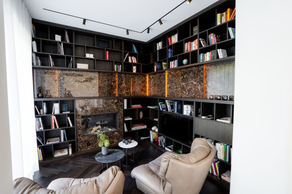 Bibliothek mit Lesesesseln und Marmorwand im Altbau